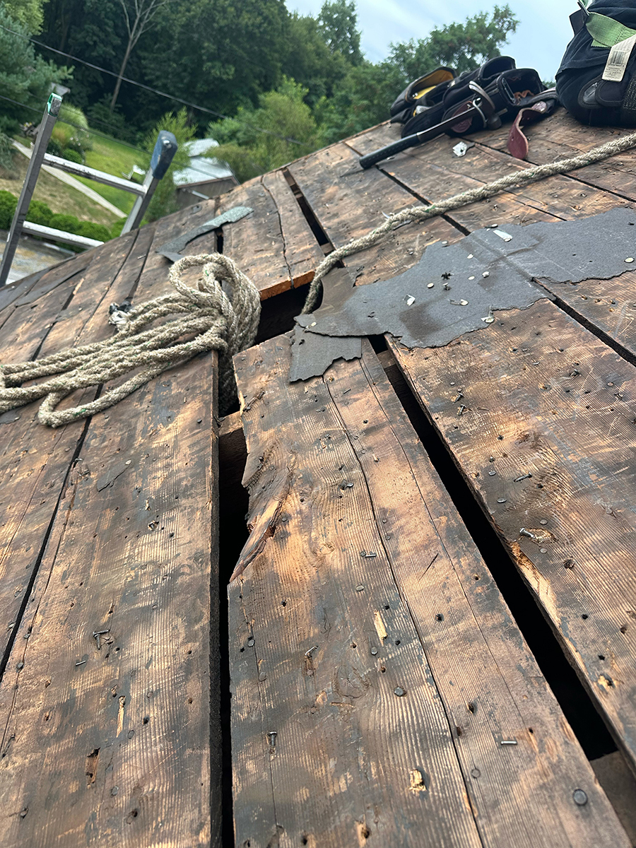 Storm-damaged roof decking exposed during repair
