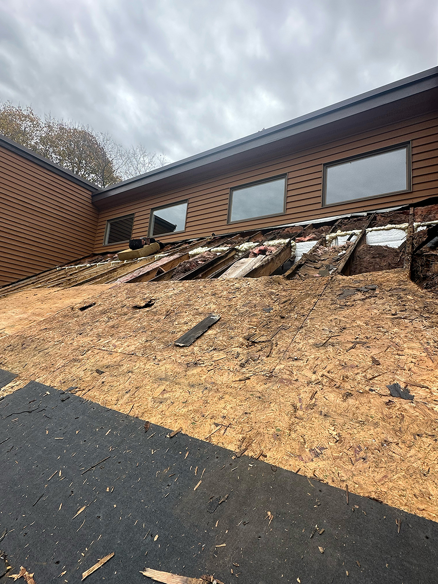 Severe storm damage to roof sheathing requiring full replacement
