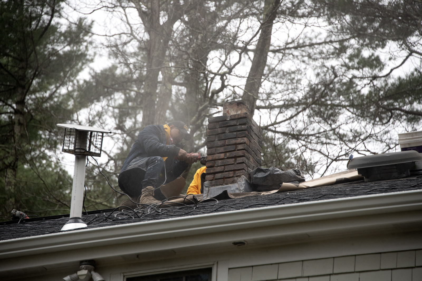 Loja technician working on chimney flashing